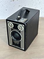 Front view showing lens, two viewfinder lenses, Brownie branding and art-deco stripes