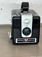 Front view showing lens, viewfinder and nameplate