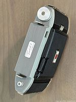 Closed camera top and side showing name badge and advance knob