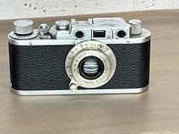 Front view of Leica camera showing lens, leatherette and chrome finish