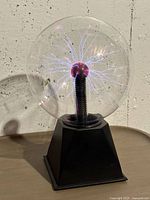 Front view of plasma ball lamp showing filaments and base