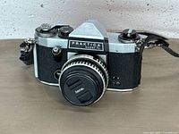 Front view of Praktica Super TL camera with lens cap and strap