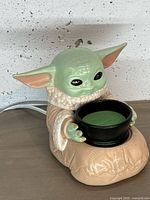 Front view of Grogu wax warmer with dish and cord visible