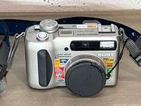 Front view showing Sony DSC-S75 with Carl Zeiss lens cap and Cyber-shot 3.3 MP labeling