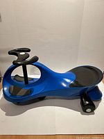 Left side view of blue PlasmaCar showing entire ride-on toy