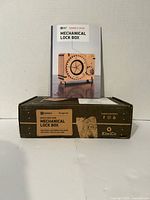 Front view of KiwiCo Mechanical Lock Box kit box and instruction booklet