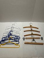 Plastic and wooden hangers arranged on surface showing quantity and types