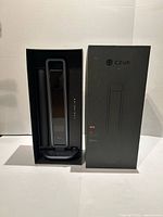 Scanner unit standing in molded box insert beside its retail box