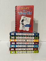 Stack of eight Diary of a Wimpy Kid hardcover books volumes 1-8