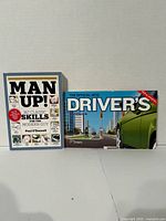 Front covers of both books: MTO Driver’s Handbook and Man Up!
