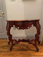 full side view of carved wooden hallway table