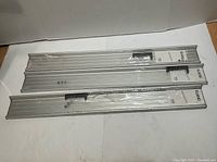 Three sealed IKEA Klang aluminum rails in original packaging