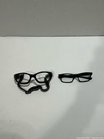 Both black frames side by side on white background