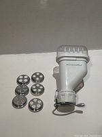 KitchenAid pasta press attachment with six discs laid out