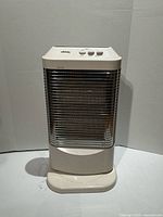 Front view of electric oscillating heater showing controls, grille, and base