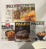 Top and bottom arrangement of five Paleo magazines