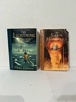 Front covers of both Percy Jackson paperbacks side by side