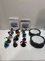 Skylanders Spyro’s Adventure Wii and PS3 games, two portals of power, and 13 character figures displayed on white backdrop