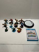 All 11 figures, Wii U game case, and Portal of Power displayed on white backdrop