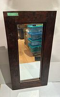 Front view of rectangular wood-framed mirror