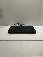 Front view of Sony BDP-S5100 Blu-ray player showing design and attached power cord