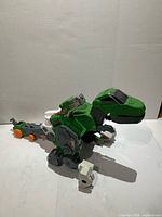 Green and white T-Rex dinosaur form side view