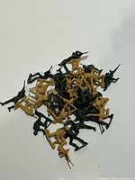 Pile of green and tan plastic toy soldiers