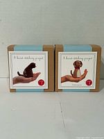 Front view showing both unopened Threadfollower felt sewing kits: Pocket Kitty Kit and Pocket Pup Kit