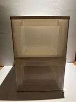 Front view of the two stacked translucent plastic storage drawer units