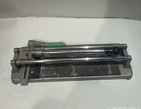 Top view of entire manual tile cutter showing base, rails, handle and cutting assembly
