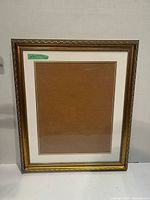 Front view of the wooden picture frame showing gold accent and double mat