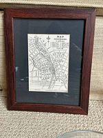 Full view of framed map showing frame, mat, and map placement