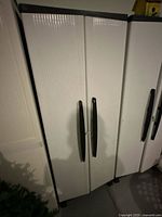 Cabinet front showing double doors and handles