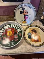 Front view of all three trays showing graphics and relative sizes