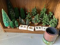 Group view showing assorted trees, boxed miniatures and rolled Village Brick Road