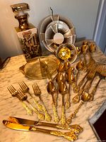 Full lot showing gold flatware, decanter, relish dish, Bavaria cup, saucer, plate