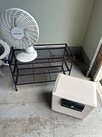 Overall view of safe, fan, and shoe shelf