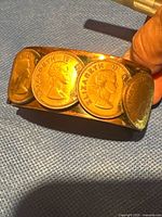 Front view showing coins decorating copper cuff