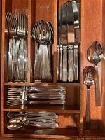 Drawer organizer holding grouped flatware pieces