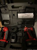 Drill, flashlight, batteries, chargers and manuals inside carry case