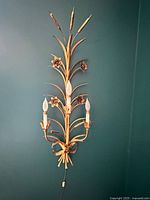 Full view of the 36 in gilt tole wall sconce mounted on wall