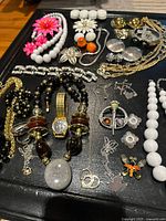 Overview of mixed jewelry lot on black surface