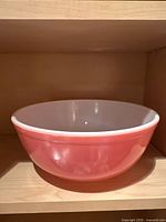 Overall view of pink Pyrex bowl on shelf