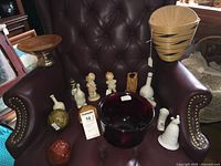 Group shot of all 16 decorative pieces on chair