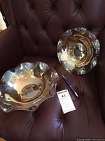 Both iridescent carnival glass bowls displayed together