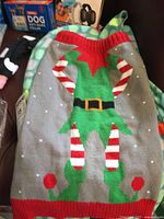 Gray knit elf-design dog sweater, anti-bark collar boxes visible
