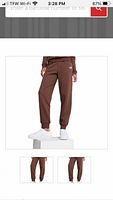 Stock image of brown Puma jogger pants on model