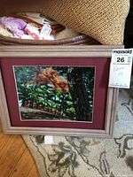 Framed oil painting depicting forest scene, shows full artwork, mat and frame