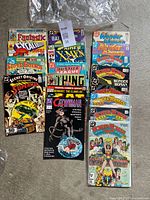 Full lot, two stacks of comics showing Wonder Woman issues on right and mixed titles on left
