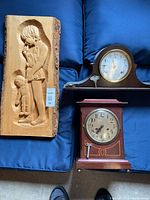 Overall view of two clocks and wood carving